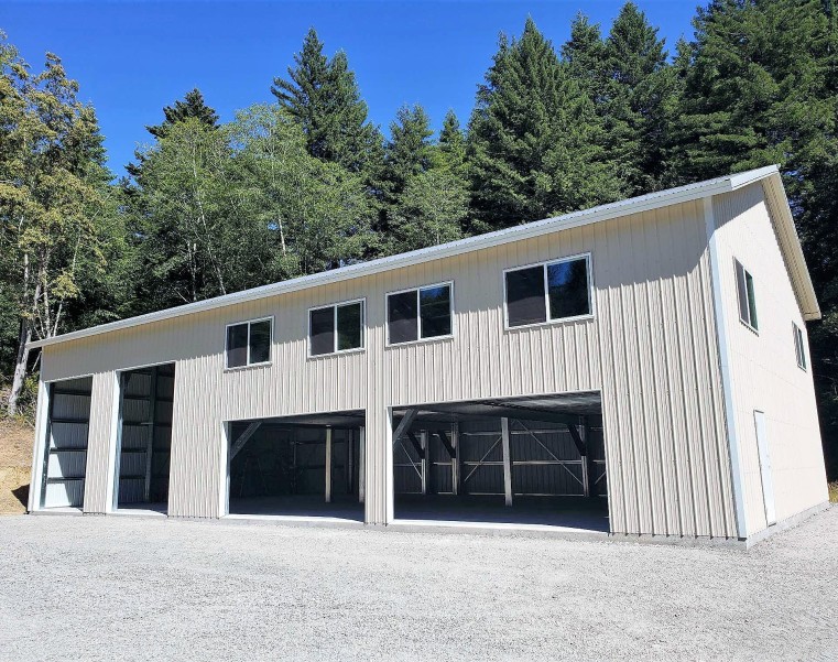 Gambrel roof metal shed with three large garage doors